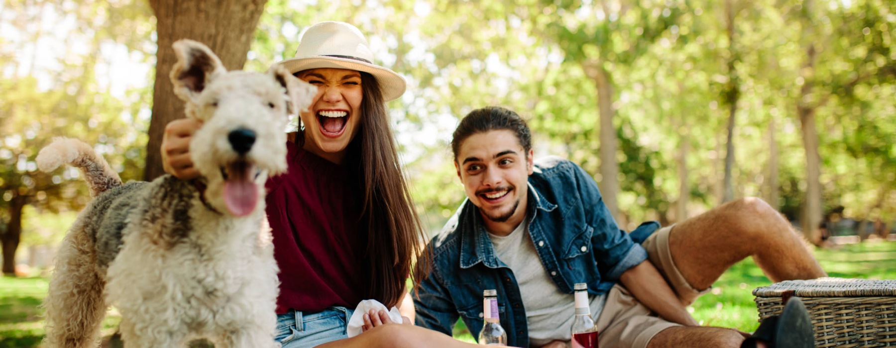 a couple with a dog in a park